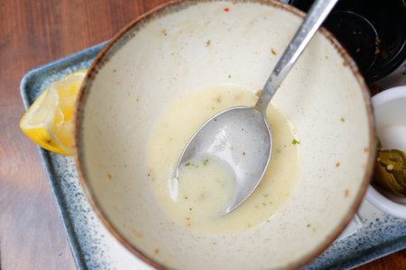 Empty bowl after a flavorful meal enjoyed at a cozy restaurantの写真素材