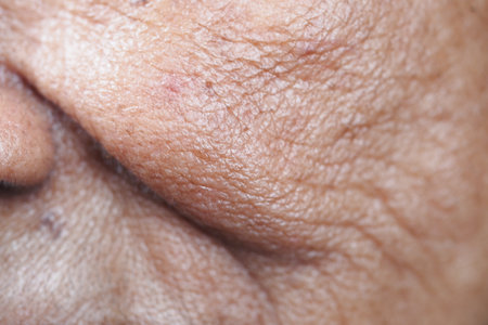 Close-up view of aged skin showing texture and detail on faceの写真素材