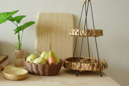 Natural decor with fruits and woven baskets on clean kitchen counterの写真素材