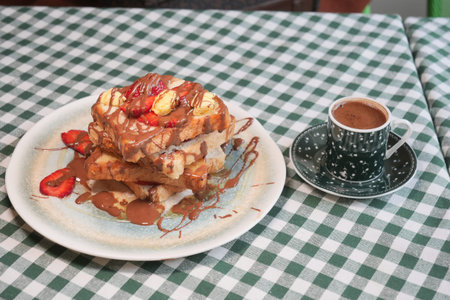 Delicious stack of French toast topped with fruit and syrup