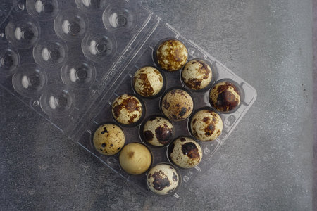 Quail eggs in a carton ready for cooking or bakingの写真素材