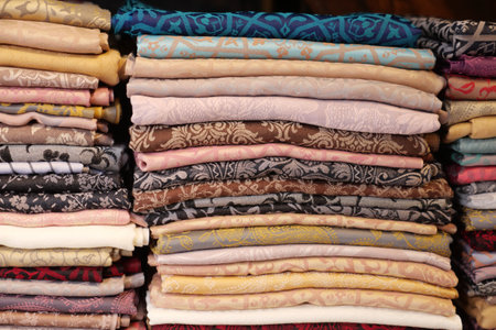 Beautifully arranged textiles in a vibrant fabric storeの写真素材