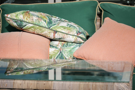 Relaxation area featuring colorful cushions and a glass tabletopの写真素材
