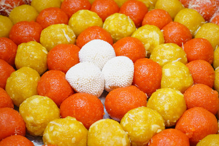 Colorful assortment of Indian sweets on festive display plattersの写真素材