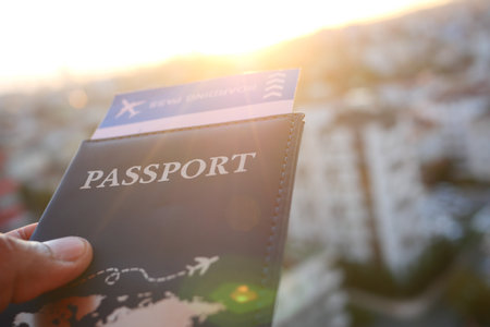 Planning a trip with a passport and boarding pass at sunsetの写真素材