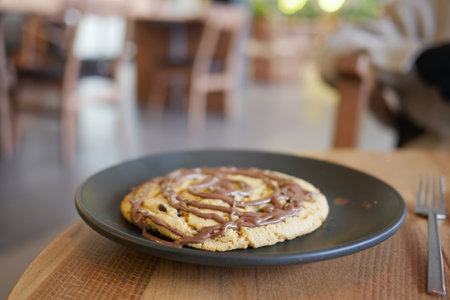 Delicious dessert with chocolate drizzle on a wooden tableの写真素材