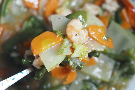 Mixed vegetable and shrimp stir-fry with vibrant colors and texturesの写真素材