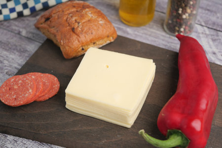 Delicious sandwich ingredients arranged on a wooden boardの写真素材