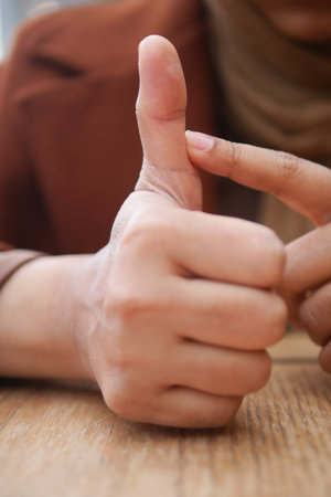 young woman suffering pain on her fingerの写真素材