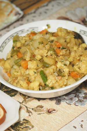 Traditional savory dish with vegetables and grains served in a bowlの写真素材