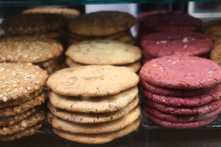 Delicious assortment of freshly baked cookies displayed on a shelfの写真素材