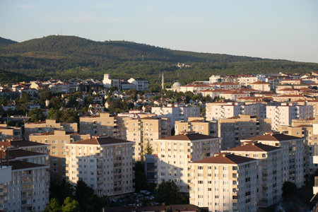 Cityscape view of residential buildings and mountains in daylightの写真素材