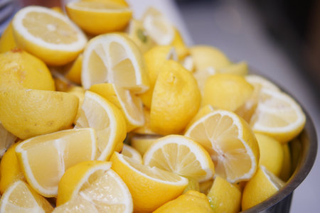 Freshly cut lemons arranged in a bowl for culinary useの写真素材