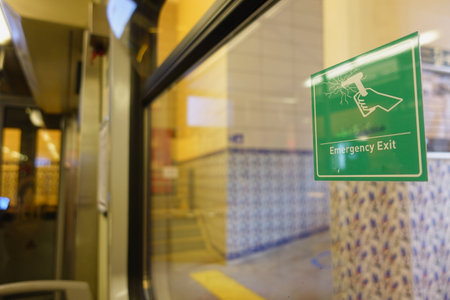 Emergency exit sign visible in public transport station interiorの写真素材