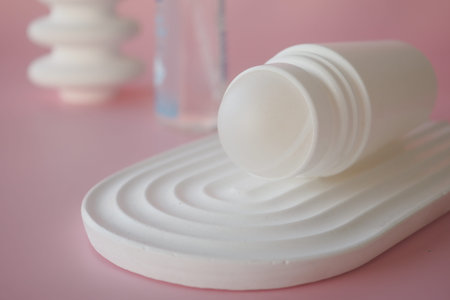 Deodorants on a textured surface with soft colors