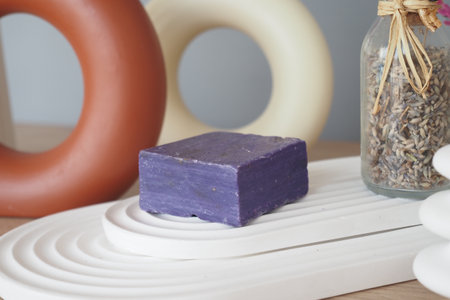 Natural lavender soap among decorative elements on a wooden surfaceの写真素材