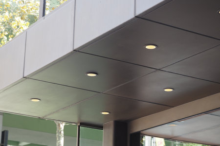 Modern architectural details of a buildings ceiling with lightsの写真素材