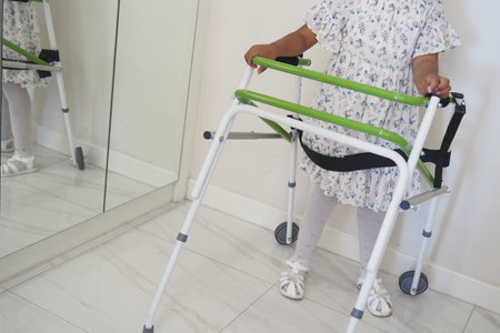 Child using a walker in a bright indoor spaceの写真素材