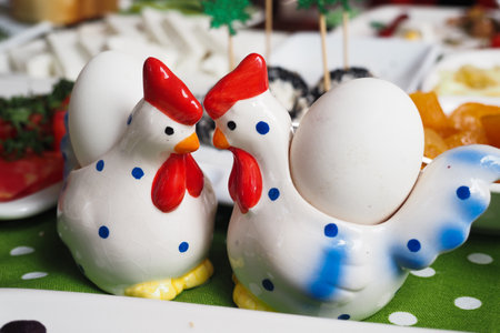 Cute chicken salt and pepper shakers on a festive dining tableの写真素材