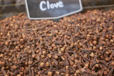 Clove spices displayed for sale at a marketplace standの写真素材