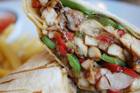Delicious wrap filled with grilled chicken and fresh vegetablesの写真素材