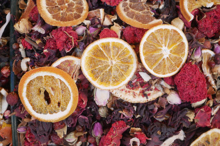 Colorful dried fruit and floral mix displayed at the marketの写真素材