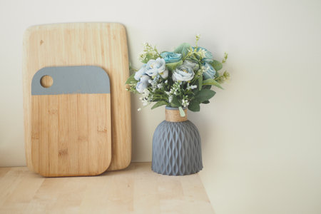 Modern kitchen decor with flowers and cutting boards in soft tonesの写真素材