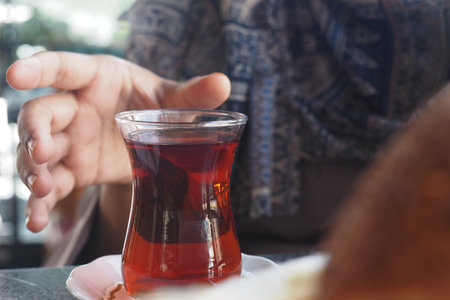 Enjoying traditional turkish tea at a local cafe during afternoon hoursの写真素材