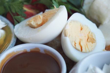 Deliciously prepared boiled eggs with dipping sauce on a tableの写真素材