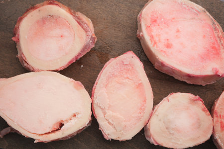 Preparing bone marrow for cooking in a kitchen workshopの写真素材