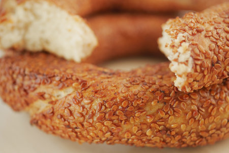 Freshly baked sesame bread rings on a plate at a local bakeryの写真素材