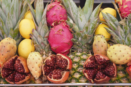 Colorful tropical fruits displayed at a market during middayの写真素材