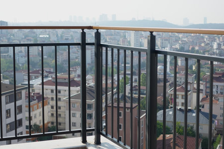 Overlooking a bustling city from a modern balcony in daylightの写真素材