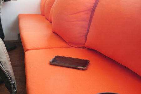 lost smart phone concept. smart phone left on a sofaの写真素材