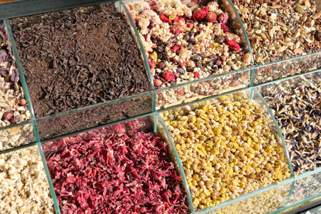 Colorful display of dried herbs and spices in a market settingの写真素材