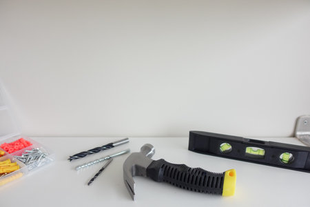 Tools and hardware arranged on a work surface for home improvementの写真素材