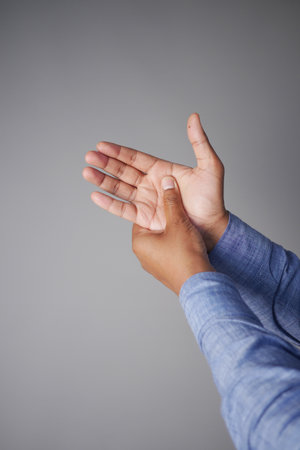 young man suffering wrist painの写真素材