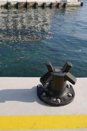 Docking fixture along the harbor with calm waters reflecting lightの写真素材
