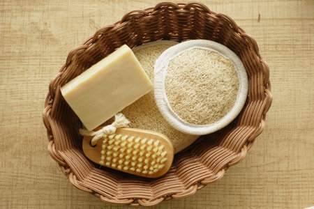 Relaxation essentials including soap and bath accessories in basketの写真素材