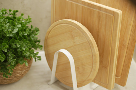 Bamboo cutting boards and small plant on kitchen counterの写真素材