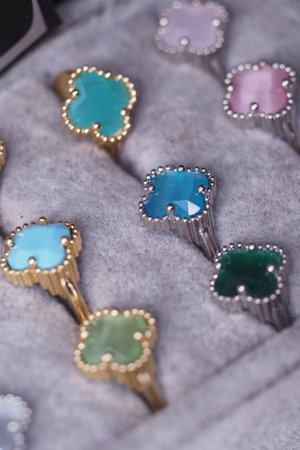 Colorful gemstone rings displayed in a plush jewelry box settingの写真素材