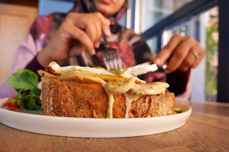 Enjoying a hearty meal at a cozy cafe during brunch hoursの写真素材
