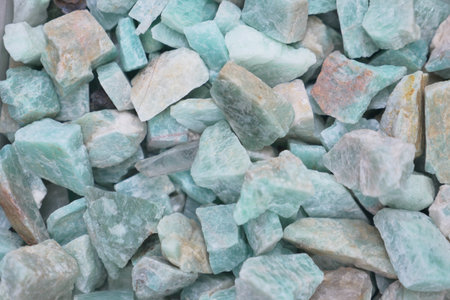 Colorful aquamarine stones scattered on surface in natural lightの写真素材