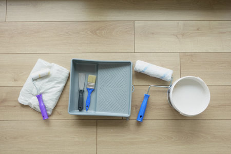 Tools for painting a room on a wooden floor in natural lightの写真素材
