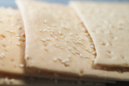 Sesame crackers displayed on a wooden tray in a warm kitchenの写真素材