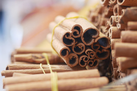 Stacks of aromatic cinnamon sticks ready for culinary useの写真素材