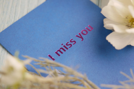 Expressing feelings with a heartfelt message on a blue cardの写真素材
