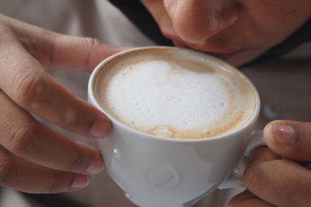 Enjoying a warm cup of coffee in a cozy settingの写真素材