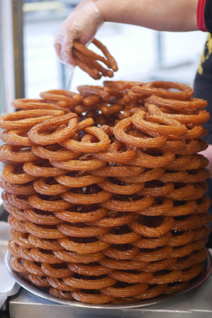 Stacked of Turkish dessert, Tulumba ready for serving in a busy market