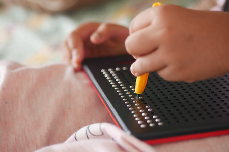 Child engaged in creative activity with a dot-matrix board at home